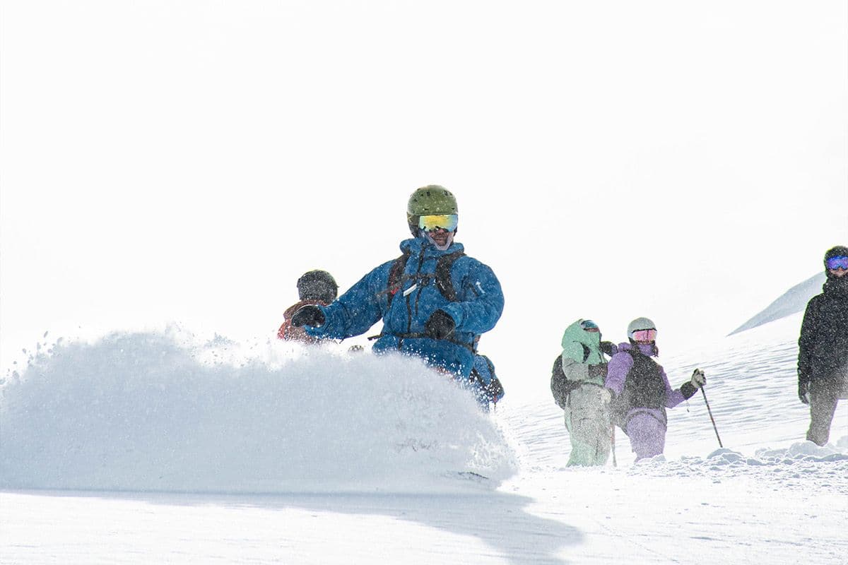 A family skiing together on a CMH heli-ski trip